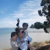 kvinna på stranden med två barn